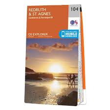 Image of walkers on a beach with a sunset